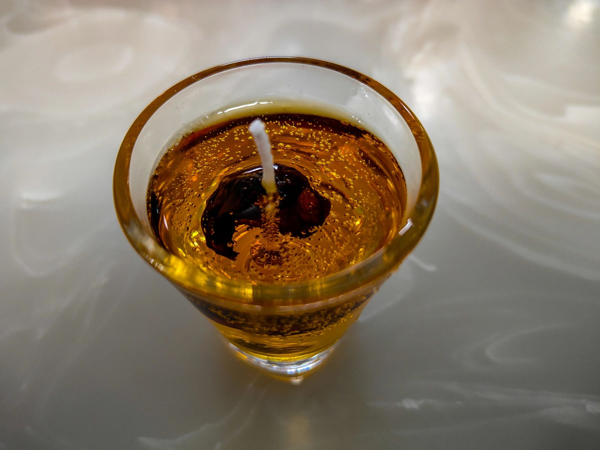 amber colored gel candle with botanical inclusions, styled for home decor, decorative candle photography