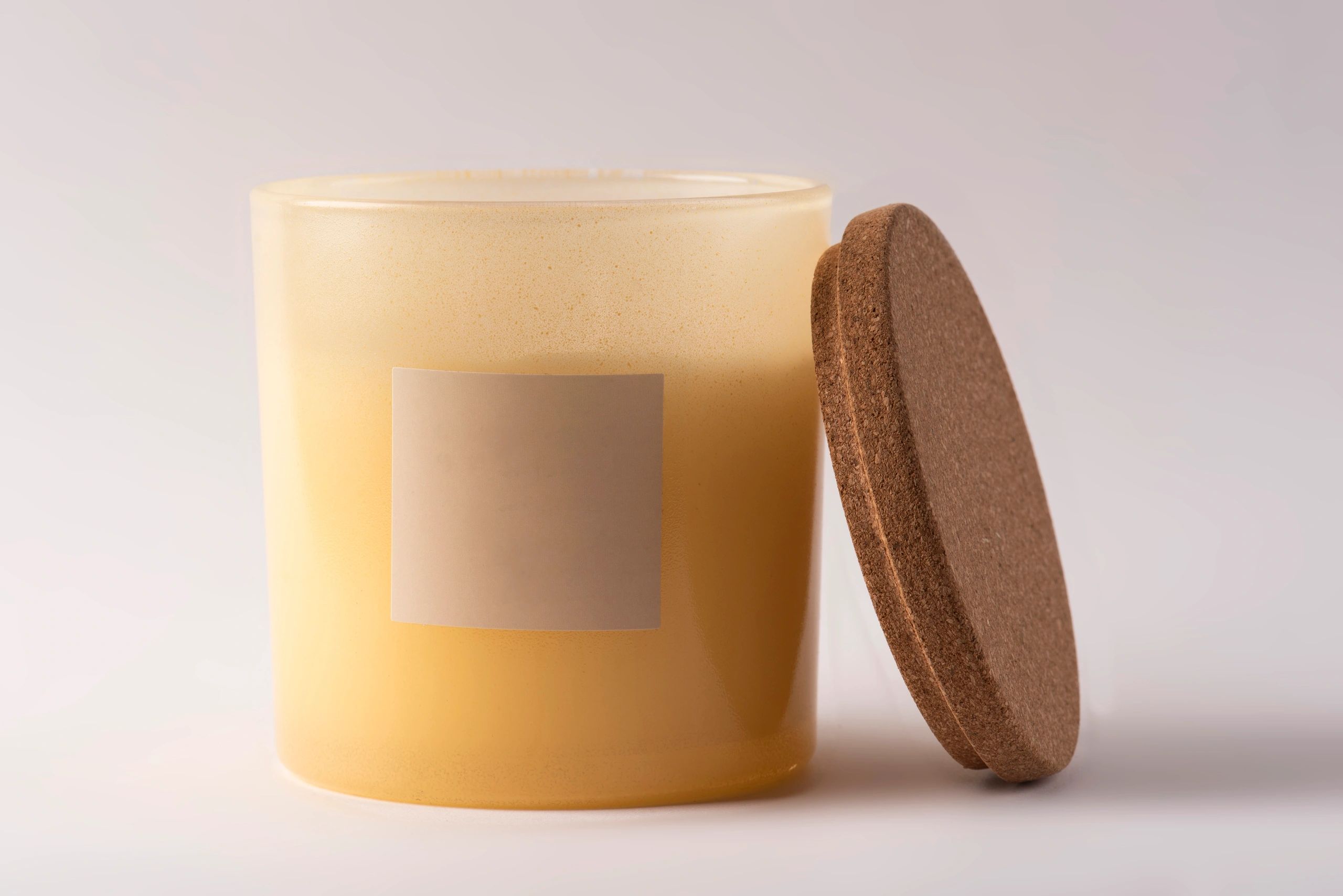 creamy white soy candle in frosted glass jar, minimal label, soft background, elegant product photography