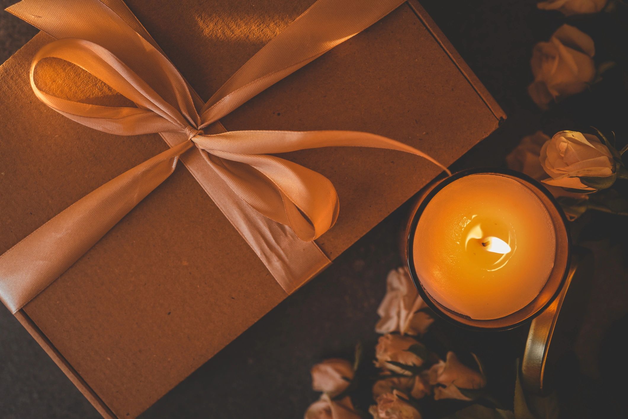 trio of assorted candles in a gift box with ribbon, cozy and inviting presentation, warm candle gift set photography