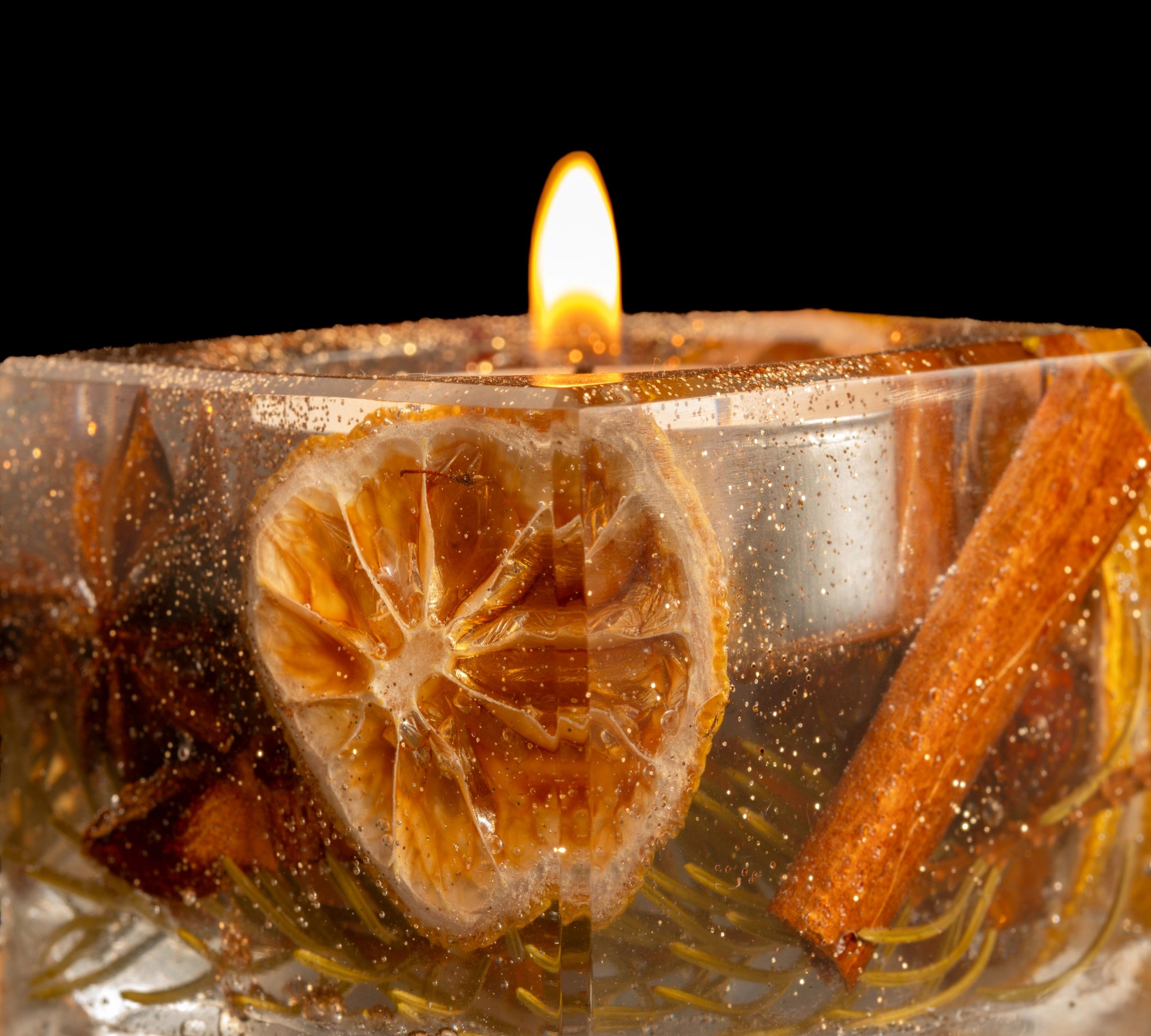 amber colored gel candle with botanical inclusions, styled for home decor, decorative candle photography